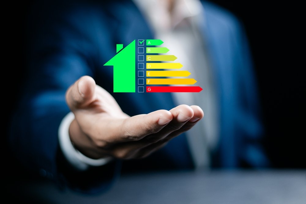 Hand holding energy efficiency rating symbol