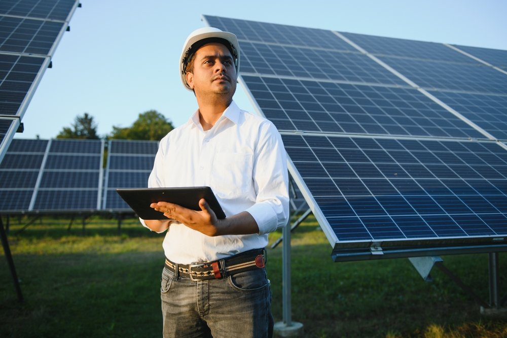 Portrait of young engineer consultant standing by solar panels