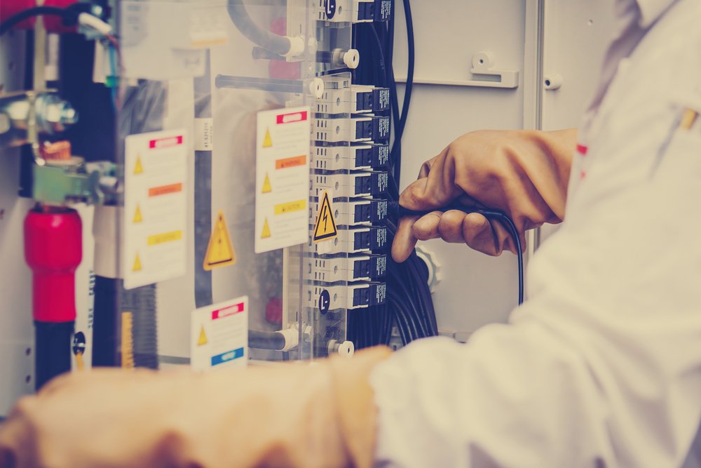 Technician testing solar inverter connections with multimeter